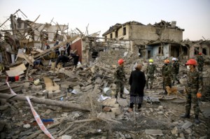 Search and rescue teams work on a blast site hit by a rocket in the city of Ganja