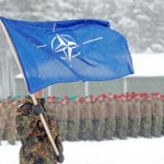 A soldier carries the NATO flag during German Minister of Defence Ursula von der Leyen's visit to German troops deployed as part of NATO enhanced Forward Presence (eFP) battle group in Rukla military base