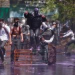 Kashmiri students shout slogans as they throw pieces of bricks and stones towards Indian policemen (unseen) during a protest in Srinagar April 24, 2017.  REUTERS/Danish Ismail - RTS13O4U