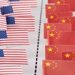 Conceptual image of American and China flags separated by dotted line